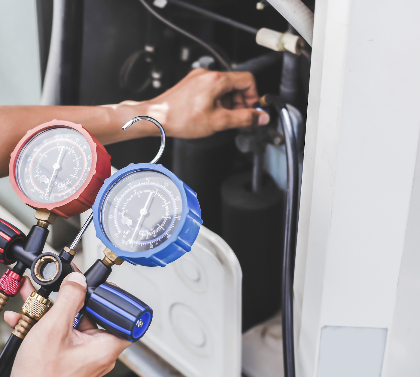 HVAC technician with gauges